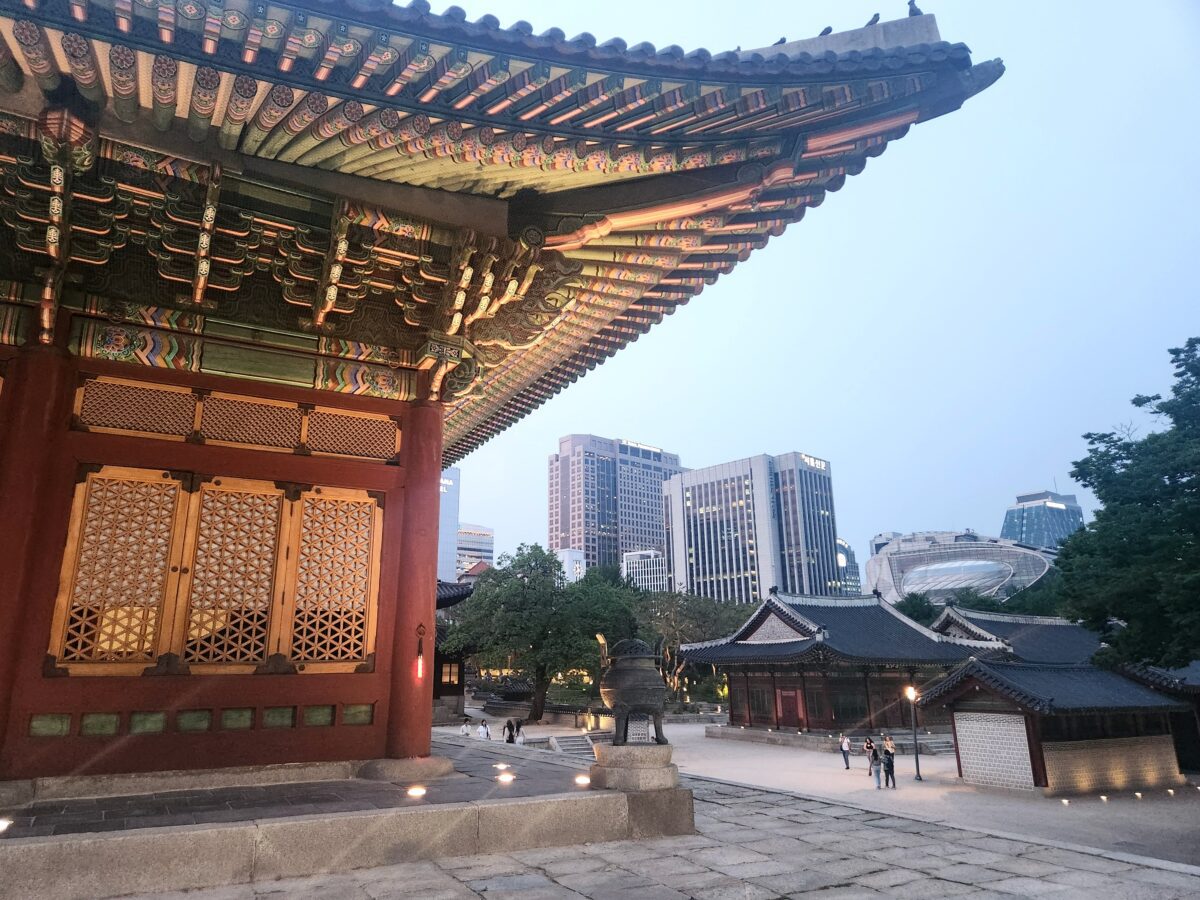 Bukhansan hiking — traditional Korean palace with modern Seoul skyline behind
