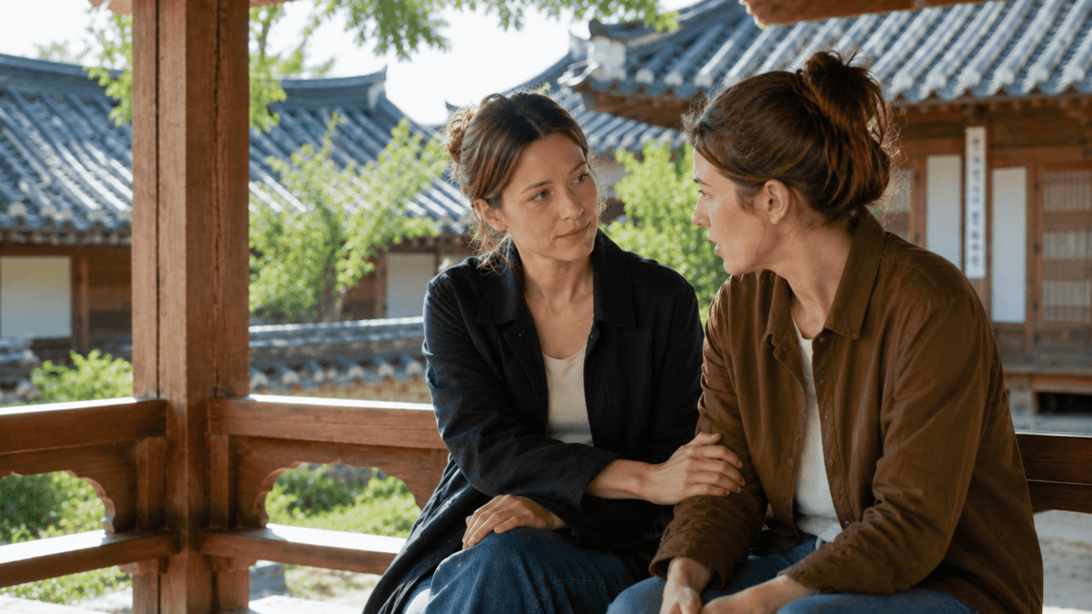 Earth element K-Saju — woman listening to a friend at a hanok village pavilion