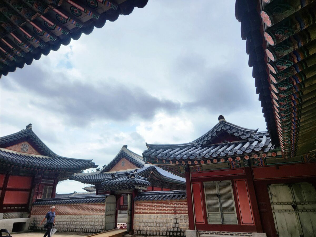 Layered palace gates at Gyeongbokgung, open but unreached — almost choosing pattern