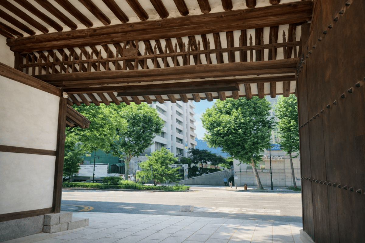 MBTI personality types timing — traditional Korean gate opening to modern city street