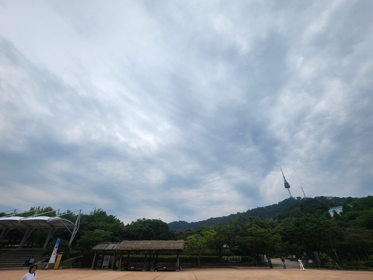 Namsan Park cloudy sky with N Seoul Tower in the distance — Fire element K-Saju