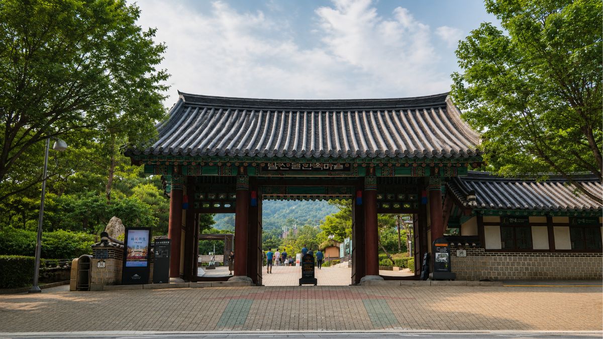solar return timing — Namsangol Hanok Village gate open to the path ahead, the question each system walks in with, Seoul