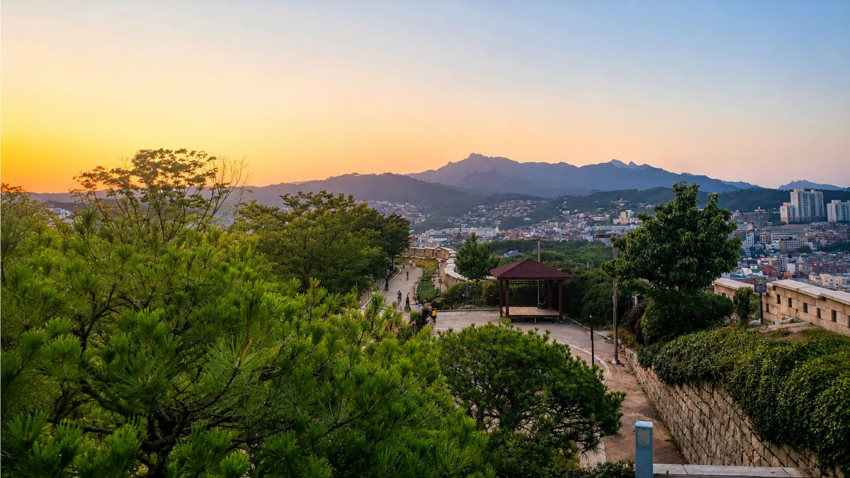 synastry compatibility — Naksan Park Seoul sunset cityview with Bugaksan mountains, timing as the third person in the relationship