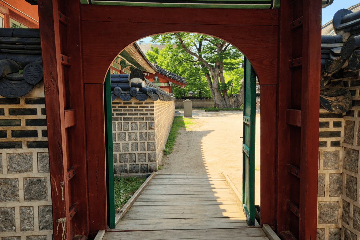 Changdeokgung Palace moon gate — the version of yourself you hide exists beyond the threshold
