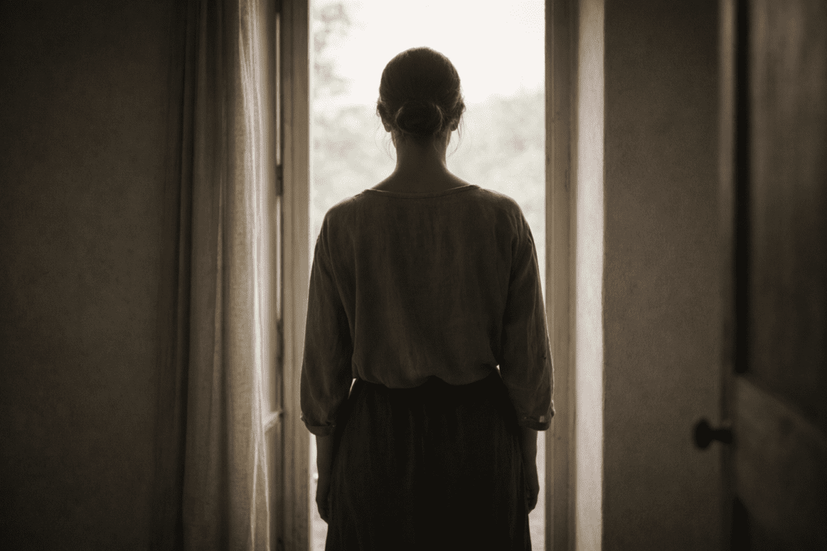 Woman standing at open door looking outward — yin yang identity shift K-Saju