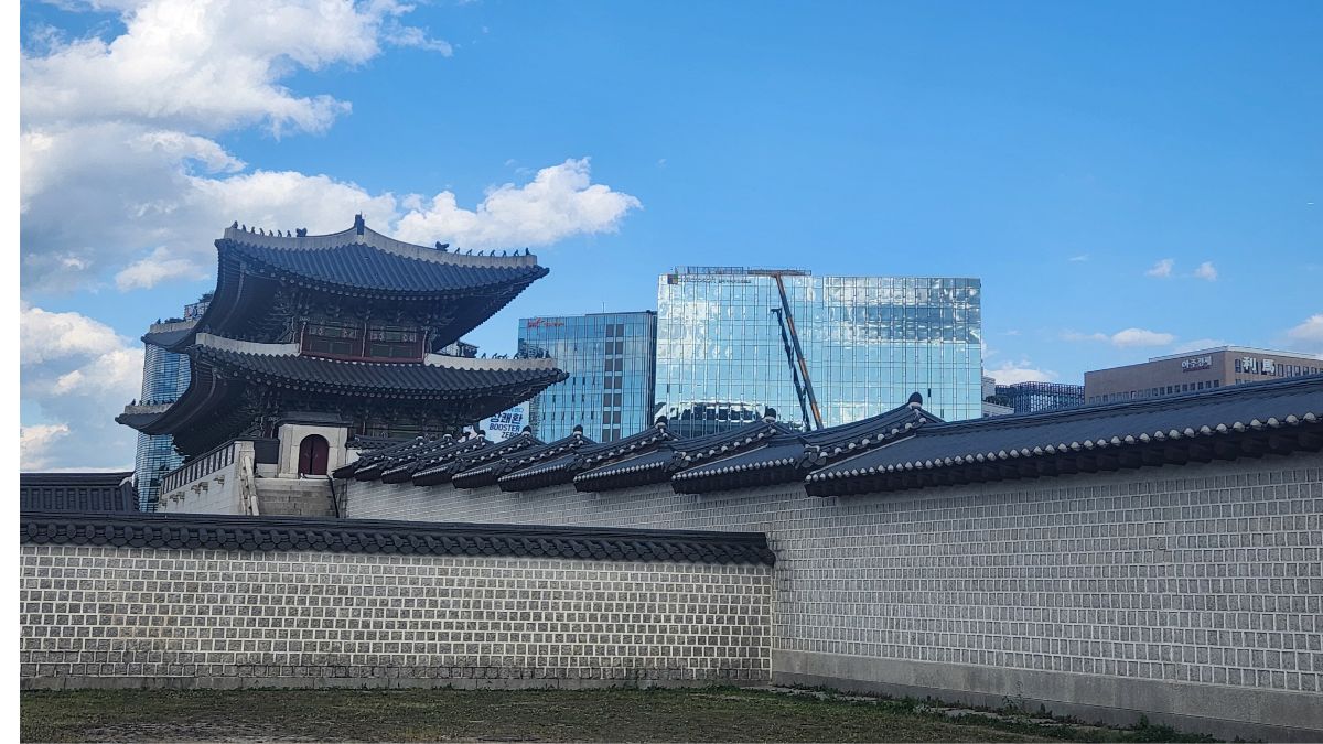 snake hour meaning in astrology — Gyeongbokgung gate rising beside a glass tower under bright midday sky