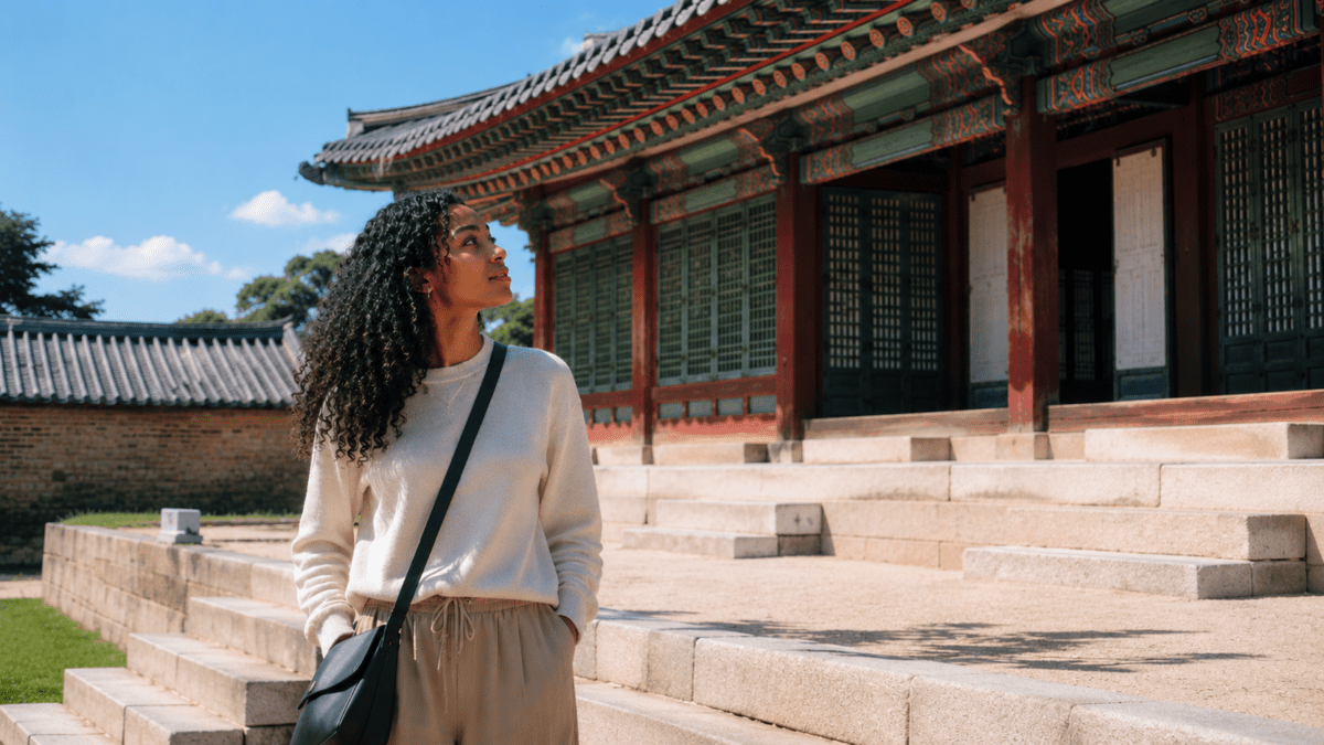 Woman looking up at a painted royal palace hall, the most elevated version of ondol floor heating built for Joseon kings