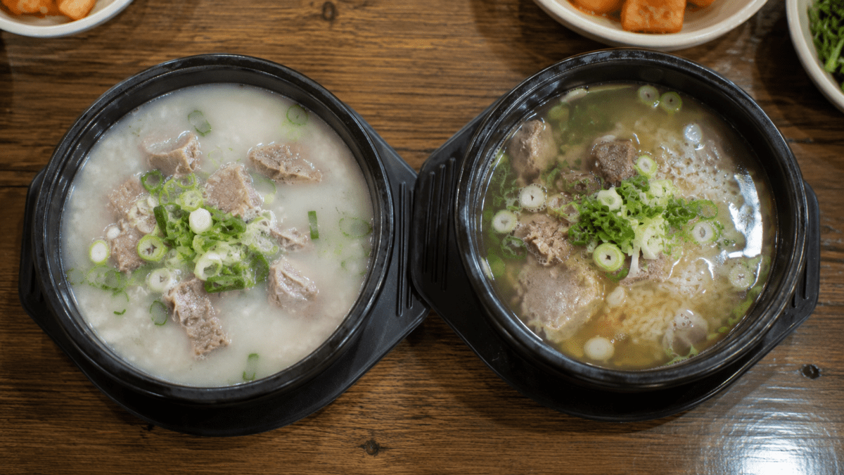 Two bowls side by side, milky white seolleongtang and clear amber gomtang, showing Korean bone broth's two main styles