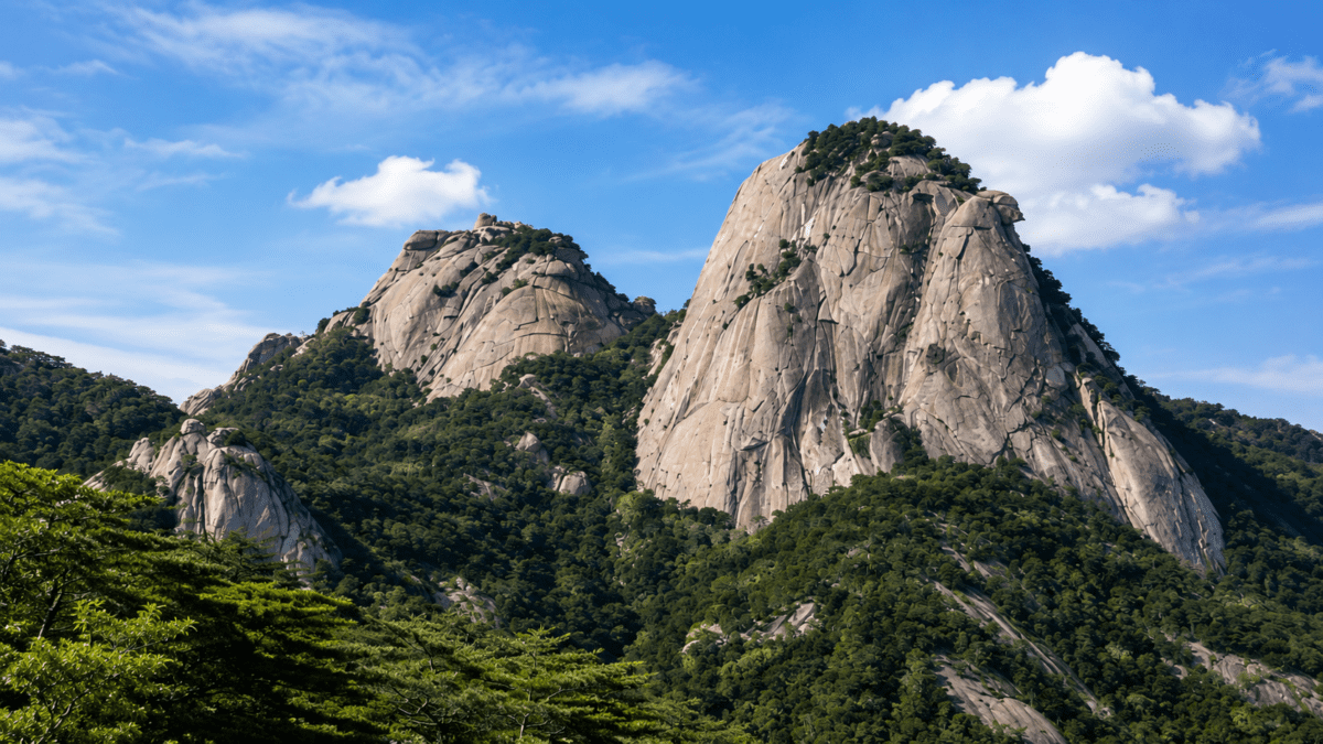 Granite peaks of Bukhansan rising sharply above the forest, the demanding northern guardian.