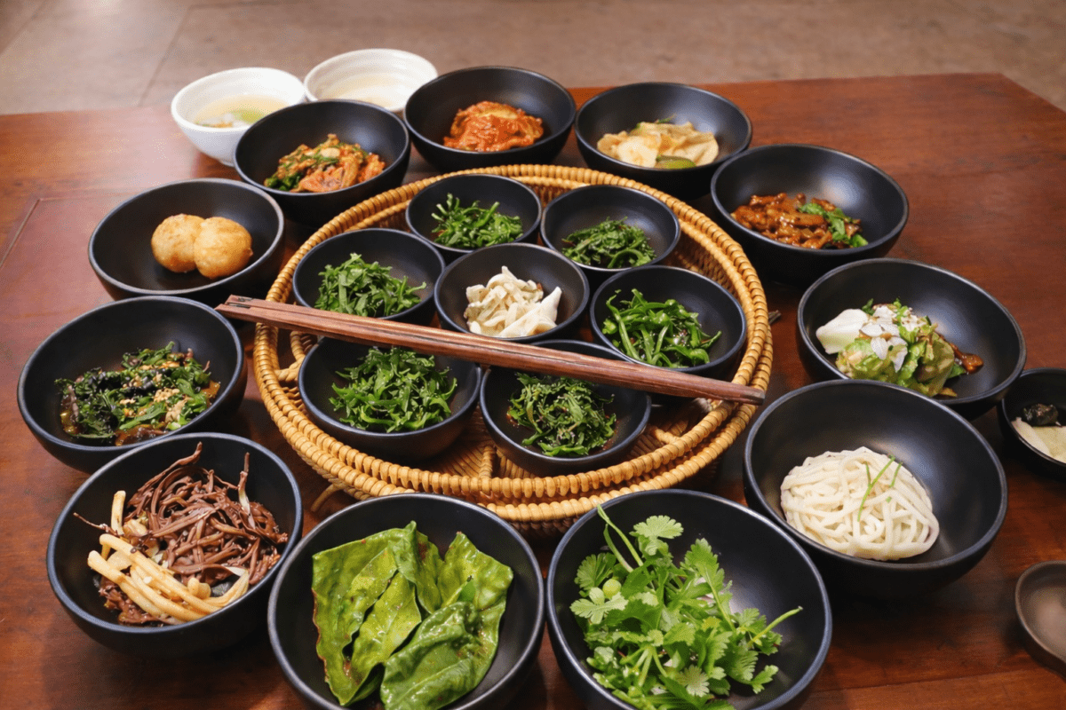 Korean temple cuisine seasonal namul vegetables arranged in black ceramic bowls