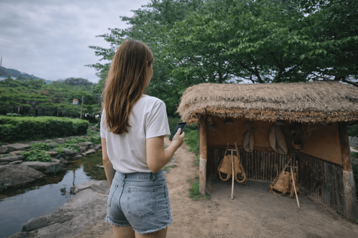 parents expectations and guilt — woman standing near thatched house holding phone psychology