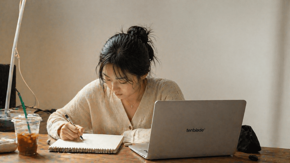 Woman studying and taking notes, extracting wrong major lessons, focused and learning from experience