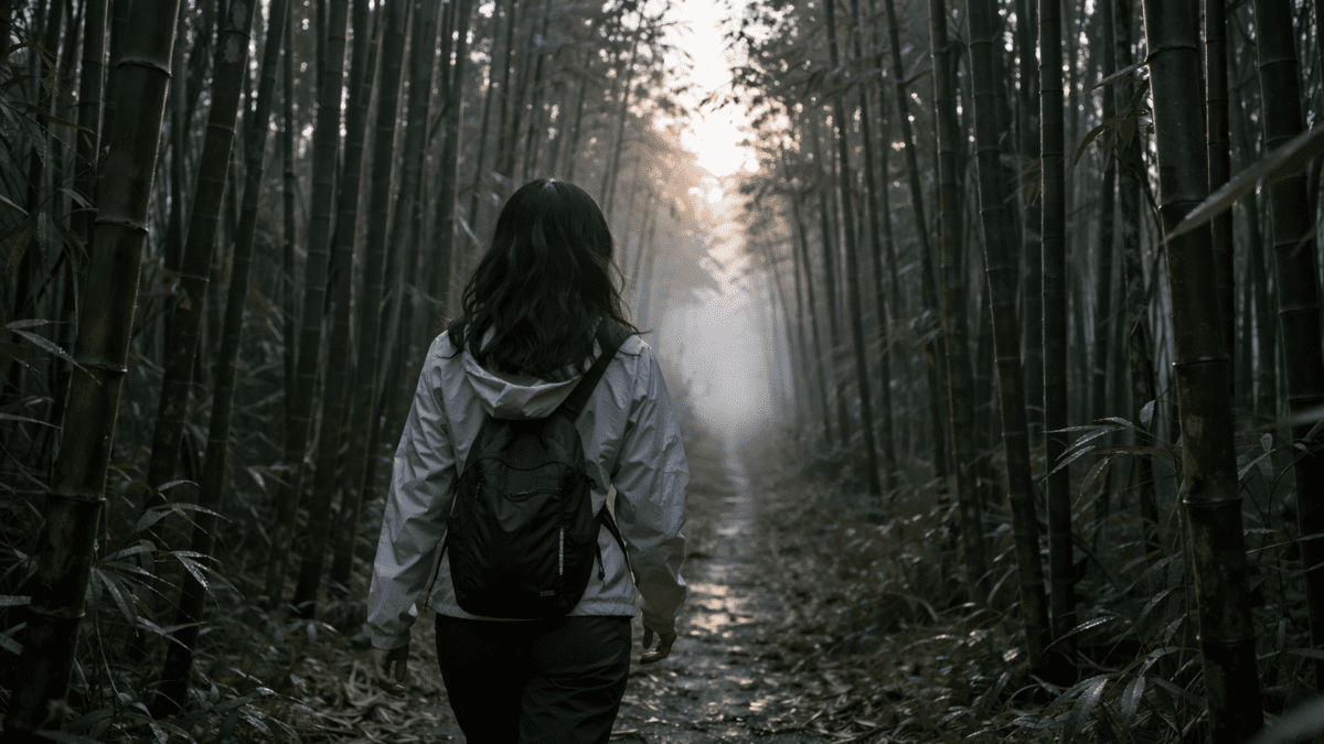 yang wood stem in K-Saju — woman walking through bamboo forest toward the light