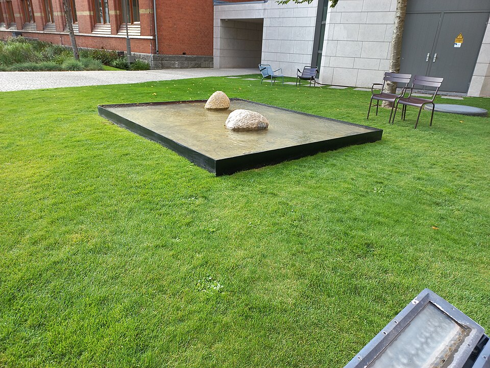 Lee Ufan silence outdoor installation with stones floating over still water and empty space