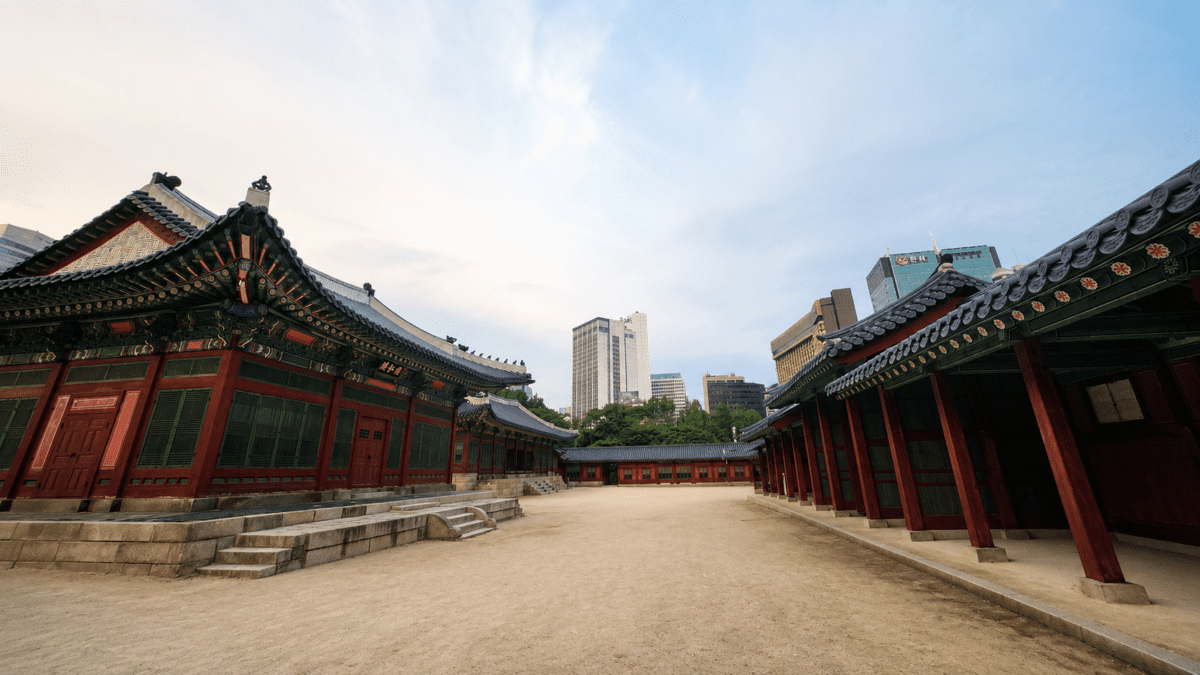 Psy dance contrasted against traditional Korean palace architecture and modern Seoul skyline