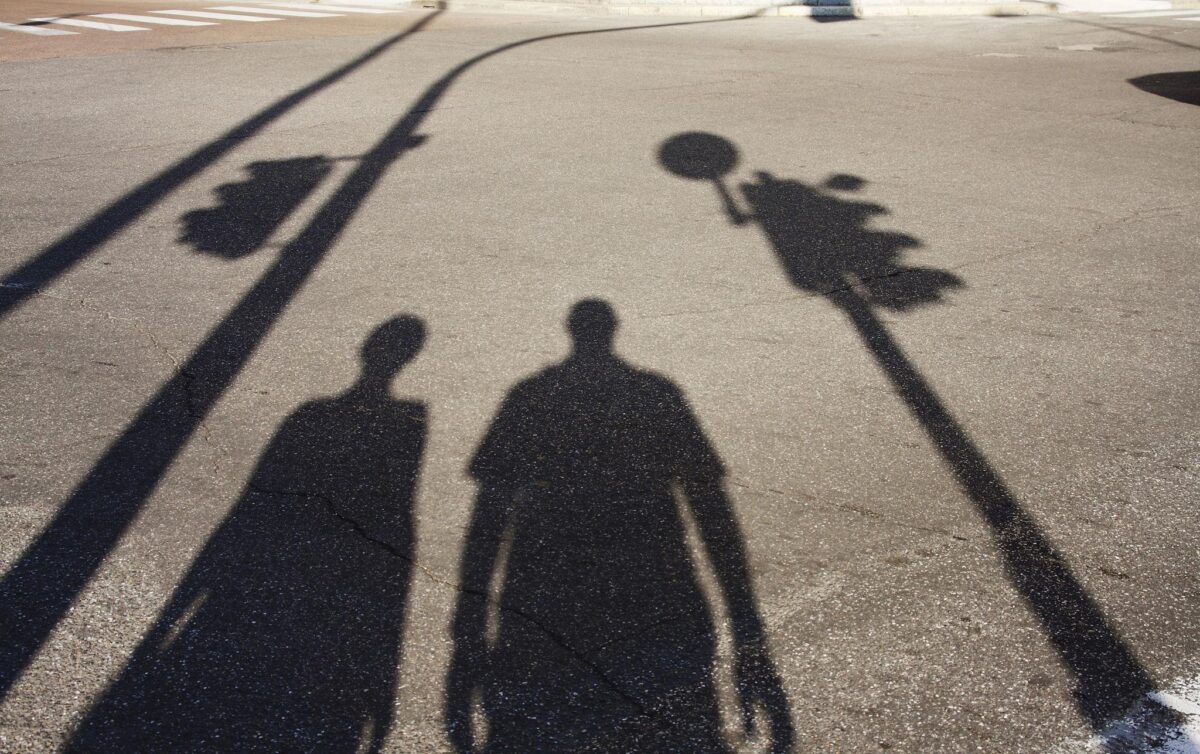 Shadows on pavement showing who you are and where you are—how strength and timing work together, with the same capacity appearing differently depending on seasonal and environmental conditions.
