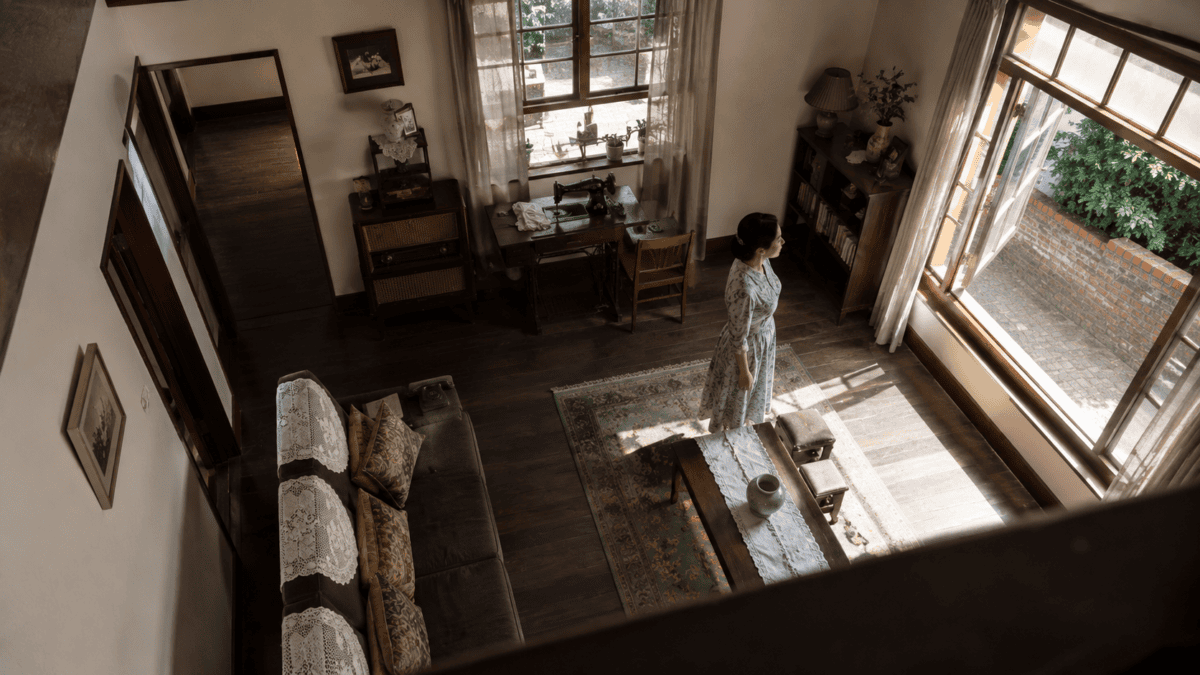 A 1960s Korean living room seen from above, a woman standing still at its center — the house Kim Ki-young turned into anatomy