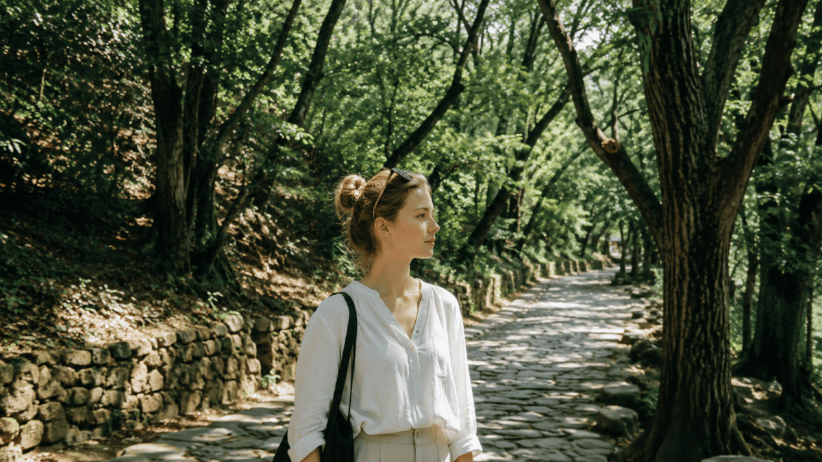 Woman stands on an old stone path — lying awake at night, what remains is the want at its honest size.