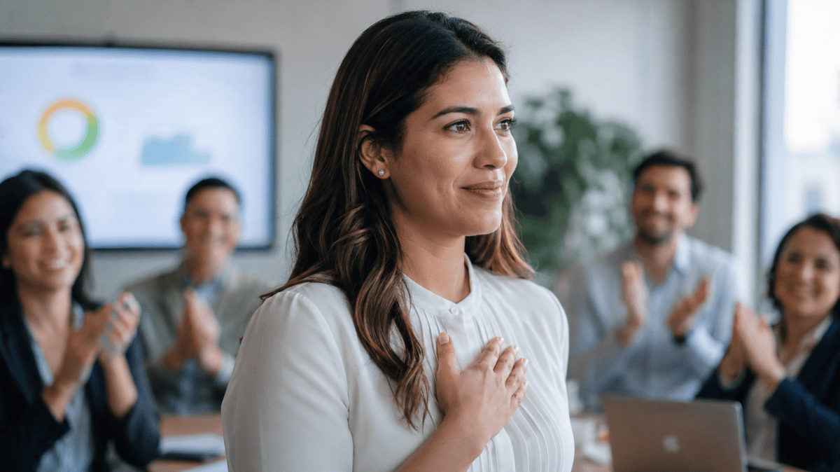 Woman takes in applause after presenting, relief and tension mixed — the quiet start of conditional love.